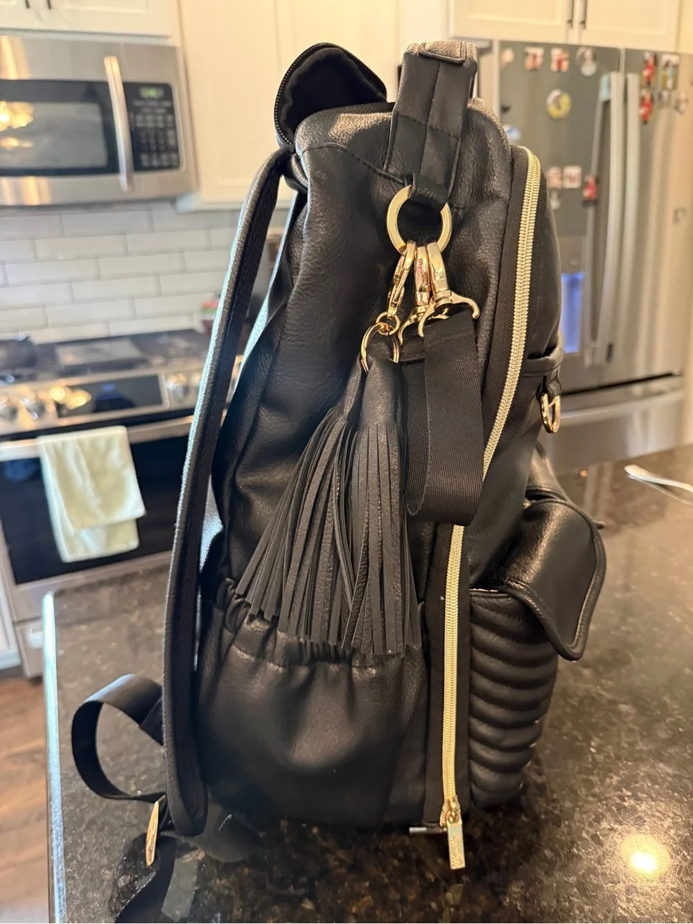 Itzy Ritzy Black Quilted Faux Leather Diaper Backpack with Tassel Charm